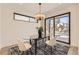 Dining room featuring a modern table and chairs, striking rug, and sliding glass doors at 372 S Humboldt St, Denver, CO 80209