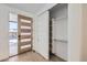 Bright entryway featuring a modern door, closet with shelving, and light wood floors at 372 S Humboldt St, Denver, CO 80209