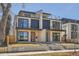 Modern two-story duplex featuring a flat roof, stone accents, and black trim at 372 S Humboldt St, Denver, CO 80209