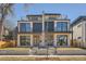 Modern two-story duplex with stone accents, black trim, and a flat roof with rooftop deck at 372 S Humboldt St, Denver, CO 80209