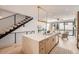 Modern kitchen island with seating, a stylish sink, and a staircase and sliding glass door nearby at 372 S Humboldt St, Denver, CO 80209