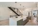 Open kitchen with white countertops, a large island, a staircase, and modern appliances at 372 S Humboldt St, Denver, CO 80209