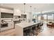 Modern kitchen with a large island, pendant lighting, stainless steel appliances, and hardwood floors at 372 S Humboldt St, Denver, CO 80209