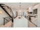 Spacious kitchen featuring a large island, modern cabinetry, stainless appliances, and a staircase at 372 S Humboldt St, Denver, CO 80209