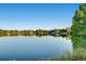 Beautiful lake view with a calm reflection, framed by lush greenery and blue skies at 372 S Humboldt St, Denver, CO 80209