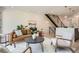 Stylish living room featuring a leather sofa, modern decor, hardwood floors, and a staircase at 372 S Humboldt St, Denver, CO 80209