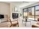 Cozy living room with a fireplace, neutral furniture, hardwood floors, and a large window at 372 S Humboldt St, Denver, CO 80209