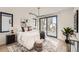 Bright main bedroom featuring modern lighting, access to a balcony, and minimalist decor at 372 S Humboldt St, Denver, CO 80209