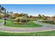 A well-manicured park with a winding path, lush greenery, and colorful flower beds under a clear sky at 372 S Humboldt St, Denver, CO 80209