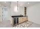 Finished basement wet bar with a wooden cabinet, black countertop, and wine refrigerator at 372 S Humboldt St, Denver, CO 80209