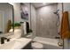 This bathroom has a tub with marble-look tile and contemporary fixtures at 1450 Syracuse St, Denver, CO 80220