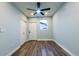This is a cozy bedroom with a ceiling fan, wood-look flooring, and a closet at 1450 Syracuse St, Denver, CO 80220