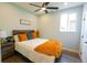 Cozy bedroom with a queen-sized bed, bright window, and a wooden nightstand with a stylish lamp at 1450 Syracuse St, Denver, CO 80220
