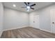 This is a cozy bedroom with a ceiling fan, wood-look flooring, and a closet at 1450 Syracuse St, Denver, CO 80220