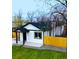 View of a charming house with a black roof and a green lawn at 1450 Syracuse St, Denver, CO 80220