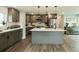 This spacious kitchen features gray cabinets, a large island with a sink, and stainless steel appliances at 1450 Syracuse St, Denver, CO 80220