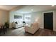 Inviting living room with neutral walls, stylish decor, wood laminate flooring, and plenty of natural light at 1450 Syracuse St, Denver, CO 80220