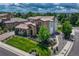 Stunning aerial view of a luxury home with beautiful landscaping, a tile roof, and a circular driveway at 9343 Vista Hill Ln, Lone Tree, CO 80124