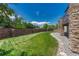 Manicured backyard with lush green lawn and brick perimeter, perfect for outdoor enjoyment at 9343 Vista Hill Ln, Lone Tree, CO 80124