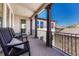 Comfortable outdoor balcony with rocking chairs and wrought iron railing offers neighborhood views at 9343 Vista Hill Ln, Lone Tree, CO 80124