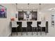 Modern bar area with ample seating, custom cabinets, and stylish pendant lighting for entertaining at 9343 Vista Hill Ln, Lone Tree, CO 80124