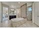 En-suite bathroom featuring a soaking tub, enclosed glass shower, double sink vanity and private toilet at 9343 Vista Hill Ln, Lone Tree, CO 80124