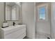 Sleek bathroom featuring a modern vanity, stylish mirror, and ample natural light at 9343 Vista Hill Ln, Lone Tree, CO 80124