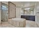 En-suite bathroom featuring a soaking tub, enclosed glass shower, double sink vanity and private toilet at 9343 Vista Hill Ln, Lone Tree, CO 80124