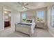 Bright bedroom with a grey bedframe, carpet and large windows overlooking the outdoors at 9343 Vista Hill Ln, Lone Tree, CO 80124