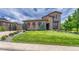 Charming stone home with well-manicured lawn and mature landscaping at 9343 Vista Hill Ln, Lone Tree, CO 80124