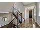 Elegant foyer showcasing beautiful hardwood floors, staircase with iron balusters, and stylish lighting at 9343 Vista Hill Ln, Lone Tree, CO 80124