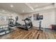 Bright home gym with hardwood floors, mirrored walls, and a variety of exercise equipment at 9343 Vista Hill Ln, Lone Tree, CO 80124