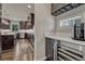 A modern kitchen boasts a wine fridge, sleek countertops, and ample cabinet space for a functional and stylish design at 9343 Vista Hill Ln, Lone Tree, CO 80124