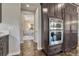 A kitchen features built-in stainless steel appliances and dark cabinetry with a view of the dining area for a stylish design at 9343 Vista Hill Ln, Lone Tree, CO 80124