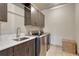 Laundry room featuring stone tile floors, modern washer and dryer units, and upper cabinets at 9343 Vista Hill Ln, Lone Tree, CO 80124