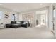 Spacious living room filled with natural light and featuring carpet floors and decorative artwork at 9343 Vista Hill Ln, Lone Tree, CO 80124