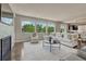 Bright living room featuring large windows, a fireplace, and comfortable seating, creating an inviting and stylish space at 9343 Vista Hill Ln, Lone Tree, CO 80124