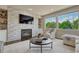A living room features a fireplace with accent wall, large windows, and cozy seating creating a warm and inviting space at 9343 Vista Hill Ln, Lone Tree, CO 80124