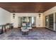 Cozy outdoor patio featuring a comfortable seating area with a decorative rug and wood ceiling at 9343 Vista Hill Ln, Lone Tree, CO 80124