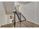 View of staircase with carpeted steps, wood floor landing and rod iron spindles and wood banister at 9343 Vista Hill Ln, Lone Tree, CO 80124