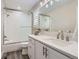 Bright bathroom with white vanity, quartz countertop, and shower with glass doors at 10487 Panther Trce, Lone Tree, CO 80124