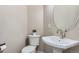 Elegant powder room featuring a pedestal sink, oval mirror, and a modern toilet at 10487 Panther Trce, Lone Tree, CO 80124