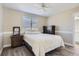 Comfortable bedroom with wood-look floors, and white plantation shutters at 10487 Panther Trce, Lone Tree, CO 80124