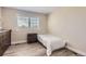 Cozy bedroom with wood-look floors, neutral walls, and plantation shutters at 10487 Panther Trce, Lone Tree, CO 80124