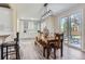 Charming dining area adjacent to the kitchen with custom cabinets and a sliding door to the backyard at 10487 Panther Trce, Lone Tree, CO 80124