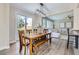 Open concept dining area flowing into a living space with a view of the backyard and modern lighting at 10487 Panther Trce, Lone Tree, CO 80124
