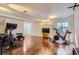 Spacious exercise room with wood floors, workout equipment, and natural light at 10487 Panther Trce, Lone Tree, CO 80124