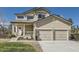 Attractive two-story house featuring a two-car garage, covered porch, and a neatly manicured front yard at 10487 Panther Trce, Lone Tree, CO 80124