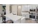 Modern kitchen featuring quartz countertops, stainless steel appliances, and ample cabinet space at 10487 Panther Trce, Lone Tree, CO 80124