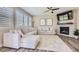 Bright living room with a fireplace, and large windows offering an abundance of natural light at 10487 Panther Trce, Lone Tree, CO 80124
